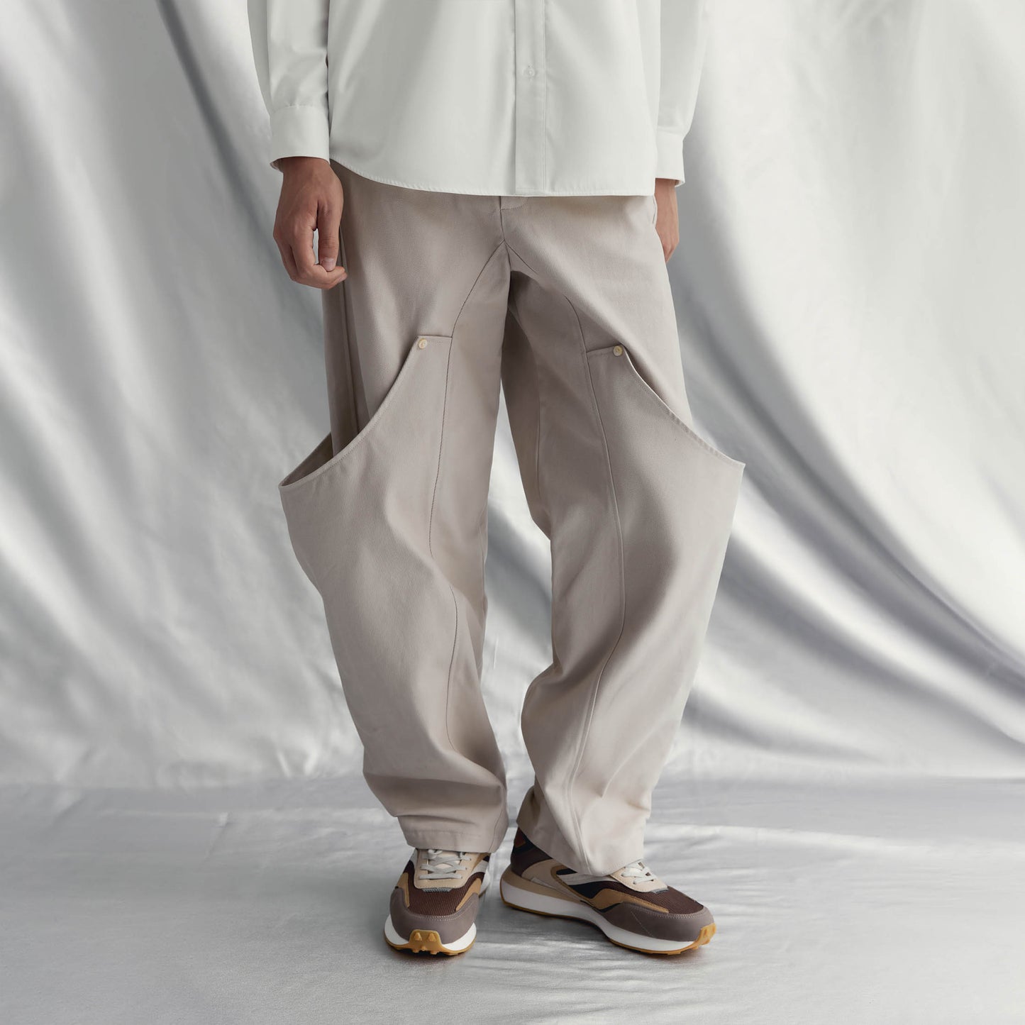 ADERSEN PANTS | BEIGE with a straight silhouette, wide legs, elasticated back, and unique cover design for a rebellious style.