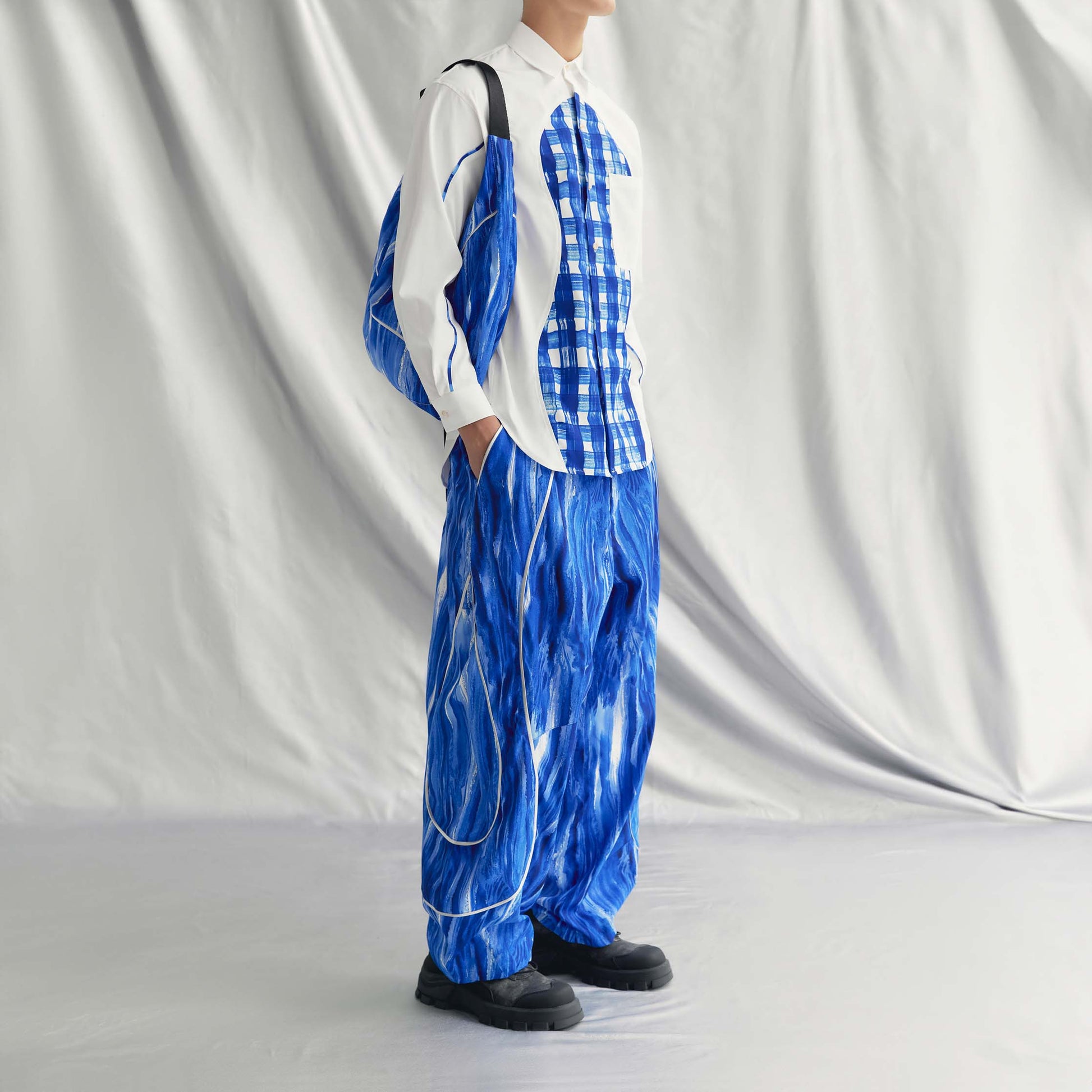 AEREN PANTS | BLUE with wide legs, elastic waistband, drawstring hem, side pockets, and a metallic line design.