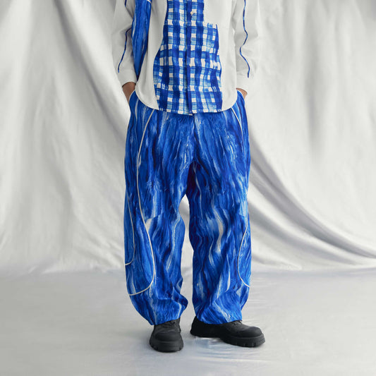 AEREN PANTS | BLUE with wide legs, elastic waistband, drawstring hem, side pockets, and a metallic line design.