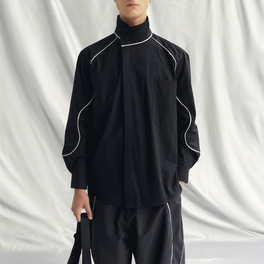 ARNE SHIRT | BLACK with band collar, buttoned cuffs, wide form, and metallic detailing from sleeves to chest.