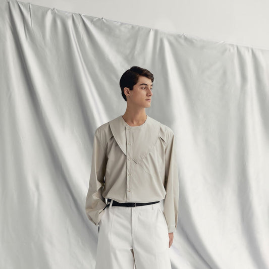 Round neck, long-sleeve cotton-poplin shirt with a wide form and cut-out design by AIN, available at ASTOUD.